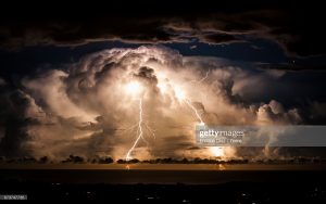 Storm clouds shroud an electrical storm of the coast of Byron Bay at night. Taken from the hinterland around Mullumbimby, early evening in Autumn as the changing sky dazzles with a natural light show of lightning bolts and billowing clouds dance in the sky for hours.