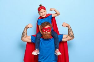 strong-powerful-dad-little-female-child-his-shoulders-show-muscles_273609-29977
